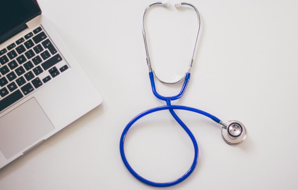 A stethoscope next to a computer